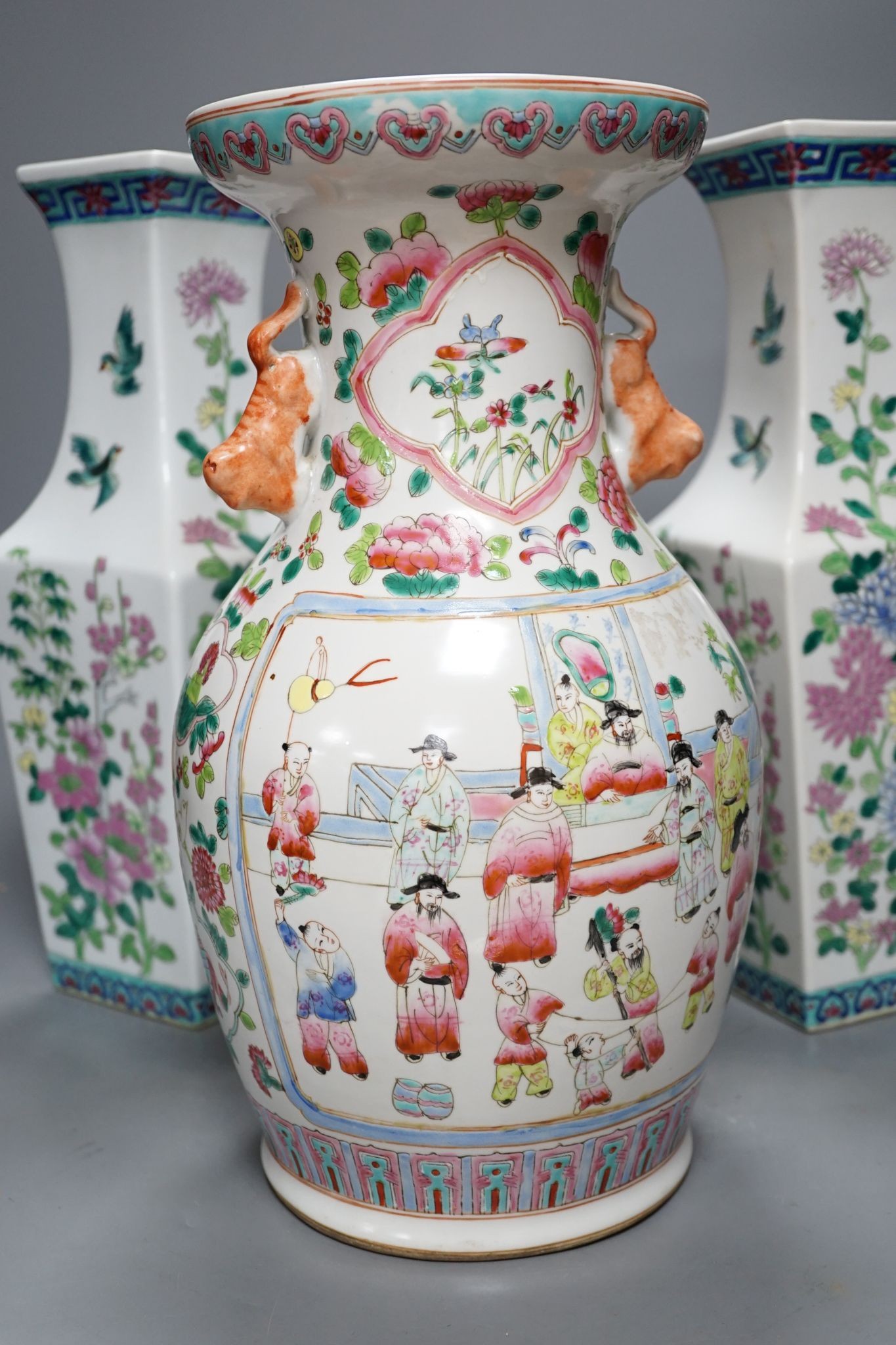 A pair of Chinese famille rose square baluster vases, and another famille rose vase, 37cm